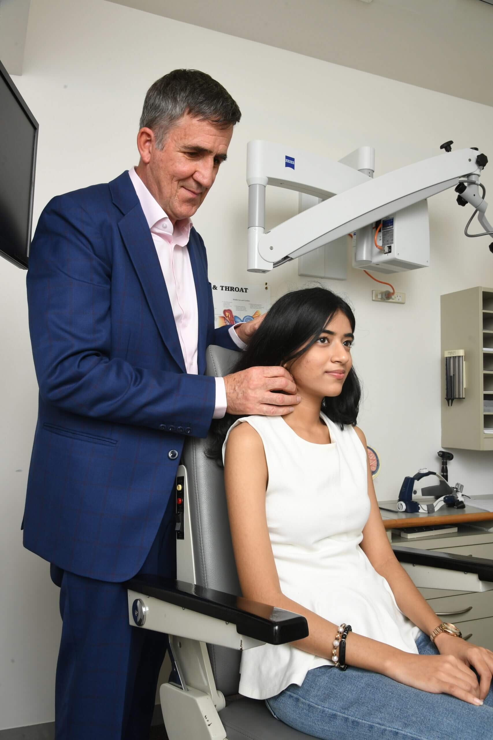 Dr Francis Hall examining a patient's neck at his Auckland thyroid clinic